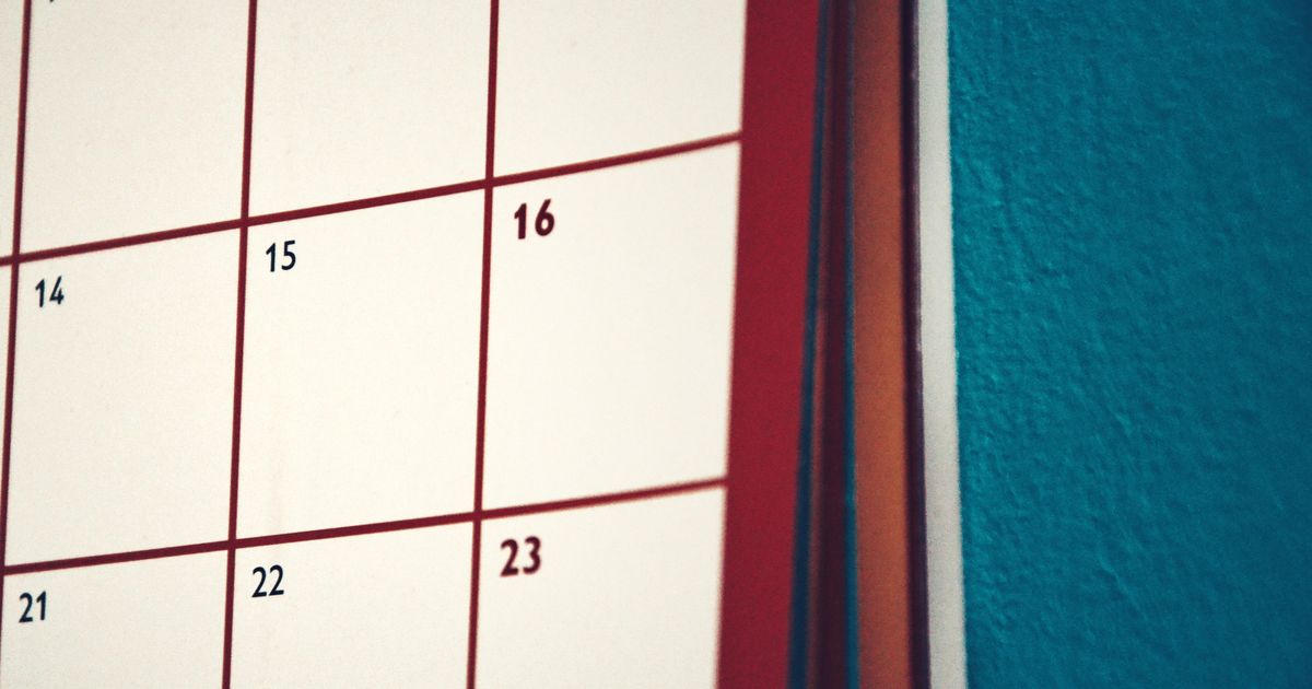 A minimalist calendar hanging on a colourful wall