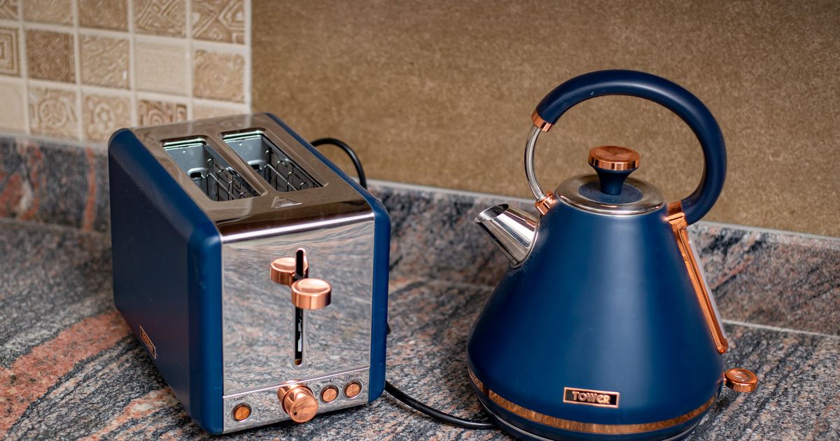 A blue kettle and matching toaster on a granite kitchen counter