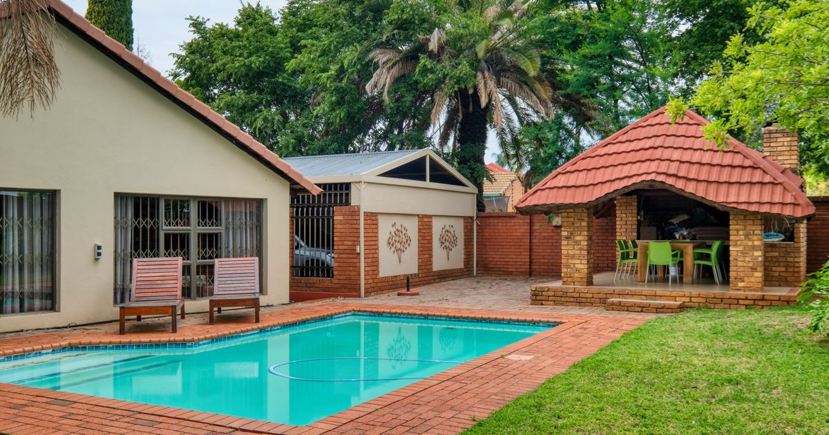 A suburban house in Pretoria with a swimming pool and green garden