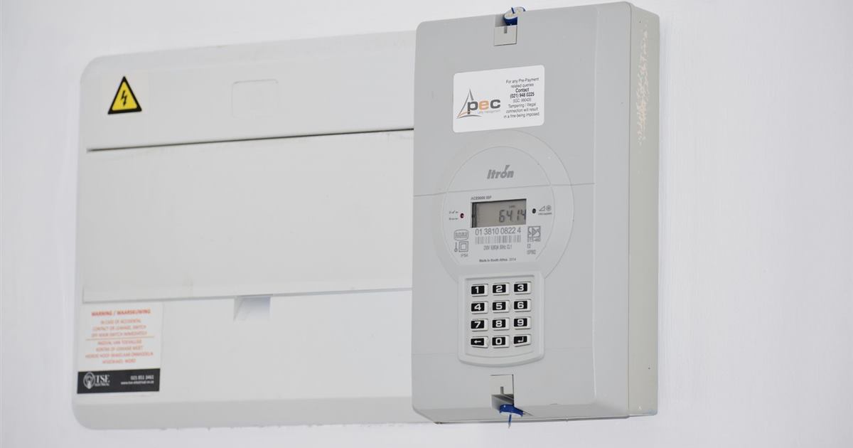 An electricity meter and fuse box mounted on a white wall in Cape Town